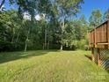 Lush, grassy backyard with mature trees and a deck at 517 Grassy Creek Run, Chester, SC 29706