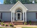The house features a front entry with a brick landing and a covered portico with white columns at 517 Grassy Creek Run, Chester, SC 29706