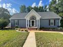 Inviting single-story home with a covered entrance and manicured front lawn at 517 Grassy Creek Run, Chester, SC 29706