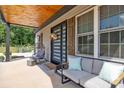 Cozy front porch offers comfortable seating and a relaxing atmosphere and a modern door at 5262 Mckenzie Trl, Conover, NC 28613