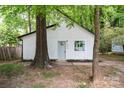 Charming home features a white exterior, black trim, and mature trees at 5444 Datha Ave, Charlotte, NC 28269