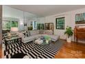 Bright living room with hardwood floors, large windows, and contemporary decor at 6001 Charing Pl, Charlotte, NC 28211
