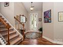 Inviting entryway with hardwood floors, staircase, overhead lighting, and decorative accents at 6398 Winding Creek Ln, Denver, NC 28037