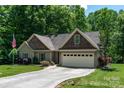 Well-maintained home with a long driveway, two-car garage, beautiful landscaping, and traditional design at 6398 Winding Creek Ln, Denver, NC 28037