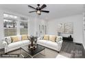 Bright living room with hardwood floors, white sofas, and decorative pillows at 642 Brynwood Dr, Rock Hill, SC 29732