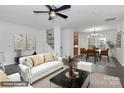 Bright living room with hardwood floors, white sofas, and view of dining area at 642 Brynwood Dr, Rock Hill, SC 29732