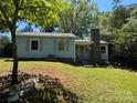 Light blue single-Gathering home with gray shutters and a stone chimney at 66 Arlington Se Ave, Concord, NC 28025