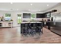 Kitchen with stainless steel appliances, dark cabinetry, and an island with bar stool seating at 665 Pointe Andrews Dr, Concord, NC 28025