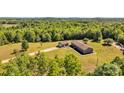 Beautiful aerial view of house and detached garage surrounded by lush forest and expansive lot at 725 Hunters Ridge Rd, Taylorsville, NC 28681