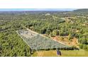 Aerial view showcasing vast wooded acreage of the property with approximate lot lines at 725 Hunters Ridge Rd, Taylorsville, NC 28681