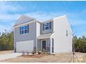 Charming two-story home with gray siding, stone accents and a two car garage at 822 N Naughton St, Chester, SC 29706