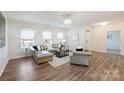Bright living room with hardwood floors, large windows, and modern furniture for comfortable living and natural light at 8853 Brakeman Dr, Waxhaw, NC 28173