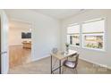 Bright office space with carpet, large windows, and a view into the living room at 8853 Brakeman Dr, Waxhaw, NC 28173
