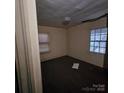 Bedroom featuring dark hardwood floors, neutral walls, and two windows with natural light at 1015 Frederick St, Shelby, NC 28150