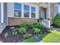 Well-maintained front yard featuring lush greenery and fresh mulch at 110 Synandra Dr # B, Mooresville, NC 28117