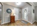 Inviting foyer with hardwood floors, painted walls and a decorative glass door at 1154 Doby Ct, Fort Mill, SC 29715