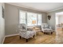 Sitting area with neutral paint, two patterned chairs, and natural light from the window at 1154 Doby Ct, Fort Mill, SC 29715
