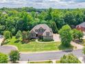 Expansive aerial view of a beautiful home nestled among lush trees and greenery on a well-manicured lot at 1260 Rittenhouse Ln, Rock Hill, SC 29732