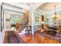 Elegant foyer featuring hardwood floors, a staircase, and an archway leading to a dining room at 1260 Rittenhouse Ln, Rock Hill, SC 29732