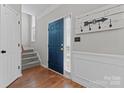 Bright foyer with hardwood floors, a blue front door, and stairway access at 13430 Norseman Ln, Huntersville, NC 28078