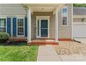 Inviting entryway with a brick pathway, white columns, and a 'Welcome' sign at 13430 Norseman Ln, Huntersville, NC 28078