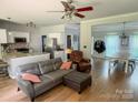 Open-concept living space featuring hardwood floors, kitchen with granite island, and dining area with ample natural light at 13430 Norseman Ln, Huntersville, NC 28078