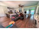 Spacious living area with hardwood floors, granite island kitchen, and sunlit dining space offering seamless flow at 13430 Norseman Ln, Huntersville, NC 28078
