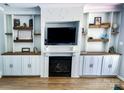 Cozy living room with a fireplace framed by built-in shelving, creating a focal point for relaxation at 13430 Norseman Ln, Huntersville, NC 28078