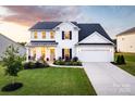 Elegant home boasting a well-maintained lawn, inviting porch, and a convenient two-car garage at 1381 Regions Blvd, Fort Mill, SC 29707