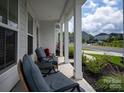 Inviting front porch with rocking chairs, offering a relaxing outdoor space to enjoy the neighborhood views at 1381 Regions Blvd, Fort Mill, SC 29707