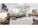 Open-concept living area showcasing hardwood floors, neutral tones, and abundant natural light at 18629 Coachmans Trce, Cornelius, NC 28031
