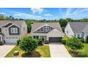 An aerial view of a well-maintained home with a green lawn, mature trees, and a serene neighborhood setting at 1957 Tablerock Dr # 59, York, SC 29745