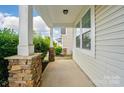 Inviting covered front porch with stone accents, offering a cozy and stylish entryway to the home at 1957 Tablerock Dr # 59, York, SC 29745