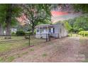 Exterior side view of fenced yard and traditional-style single-story home at 205 Stowe Acres Rd, Kings Mountain, NC 28086