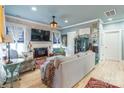 Cozy living room with a brick accent wall, a fireplace, light wood floors and plenty of seating at 23128 Goose Down Ln, Lancaster, SC 29720