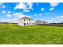 Large, grassy backyard of a home with neighboring houses and a wooden fence at 2322 Joes Lake Rd, Shelby, NC 28152