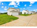 Beautiful two-story home with lush green lawn, an attached garage, and a lengthy private driveway at 2322 Joes Lake Rd, Shelby, NC 28152
