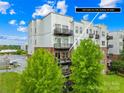 Exterior view of a modern condo building with well-maintained landscaping and balconies at 2338 Yadkin Ave # D302, Charlotte, NC 28205