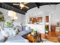 Open-concept living room with a cozy gray sofa, exposed ceiling, and an eat-in kitchen area at 2338 Yadkin Ave # D302, Charlotte, NC 28205