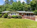 Charming brick home with stone accents, landscaped yard and a covered front porch perfect for relaxing at 24501 Canton Rd, Albemarle, NC 28001