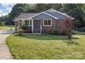 Well-maintained home featuring brick facade, blue siding, manicured lawn, and lush shrubbery at 3555 Tree Line Dr, Rock Hill, SC 29732