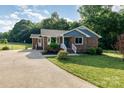 Charming brick home with blue siding accents, landscaped yard, and a concrete driveway at 3555 Tree Line Dr, Rock Hill, SC 29732