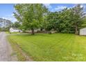 Expansive grassy yard featuring mature trees and foliage, as well as a storage shed at 403 Carpenter Parker Ln, Rock Hill, SC 29730