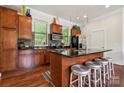 Charming kitchen with stainless steel appliances and a breakfast bar at 411 Steel Gardens Blvd, Charlotte, NC 28205