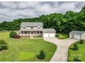 Charming two-story home with a large front porch, two car garage and lush landscaping at 4111 Jenkins Rd, Marshville, NC 28103