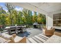 Outdoor deck with a dining table, grill, and comfortable seating, perfect for entertaining and relaxation at 4116 Spring Cove Way, Belmont, NC 28012