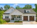 Charming home featuring a covered porch, two-car garage, and professionally landscaped yard at 4116 Spring Cove Way, Belmont, NC 28012