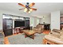 Spacious living room featuring a large entertainment center, comfortable seating, and an adjacent dining area, ideal for gatherings at 459 Presidents Ct, Charlotte, NC 28217