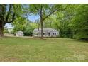 Picturesque gray home nestled amongst mature trees with spacious front yard at 500 Peigler Nw St # Lots 1 & 2, Concord, NC 28027