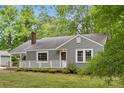 Cozy home with a gray exterior, complemented by white trim and a inviting purple front door at 500 Peigler Nw St # Lots 1 & 2, Concord, NC 28027